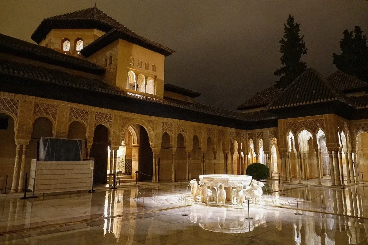 Marble courtyard with slender columns and central fountain in the Court of the Lions, Nasrid Palaces, on a private Alhambra tour in Granada, Spain