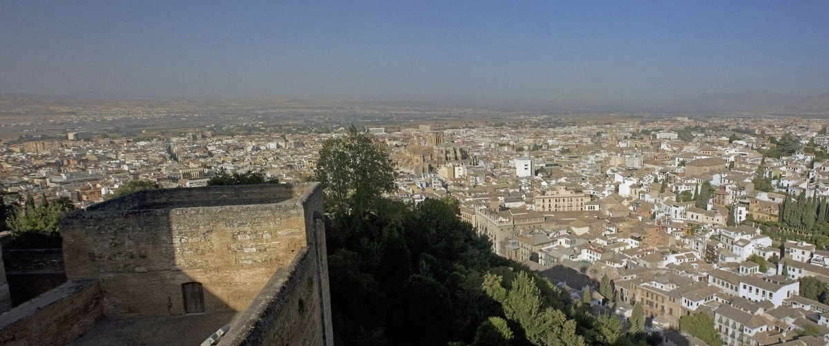 The Torre de la Vela tower of the Alhambra’s Alcazaba against a clear sky, Granada